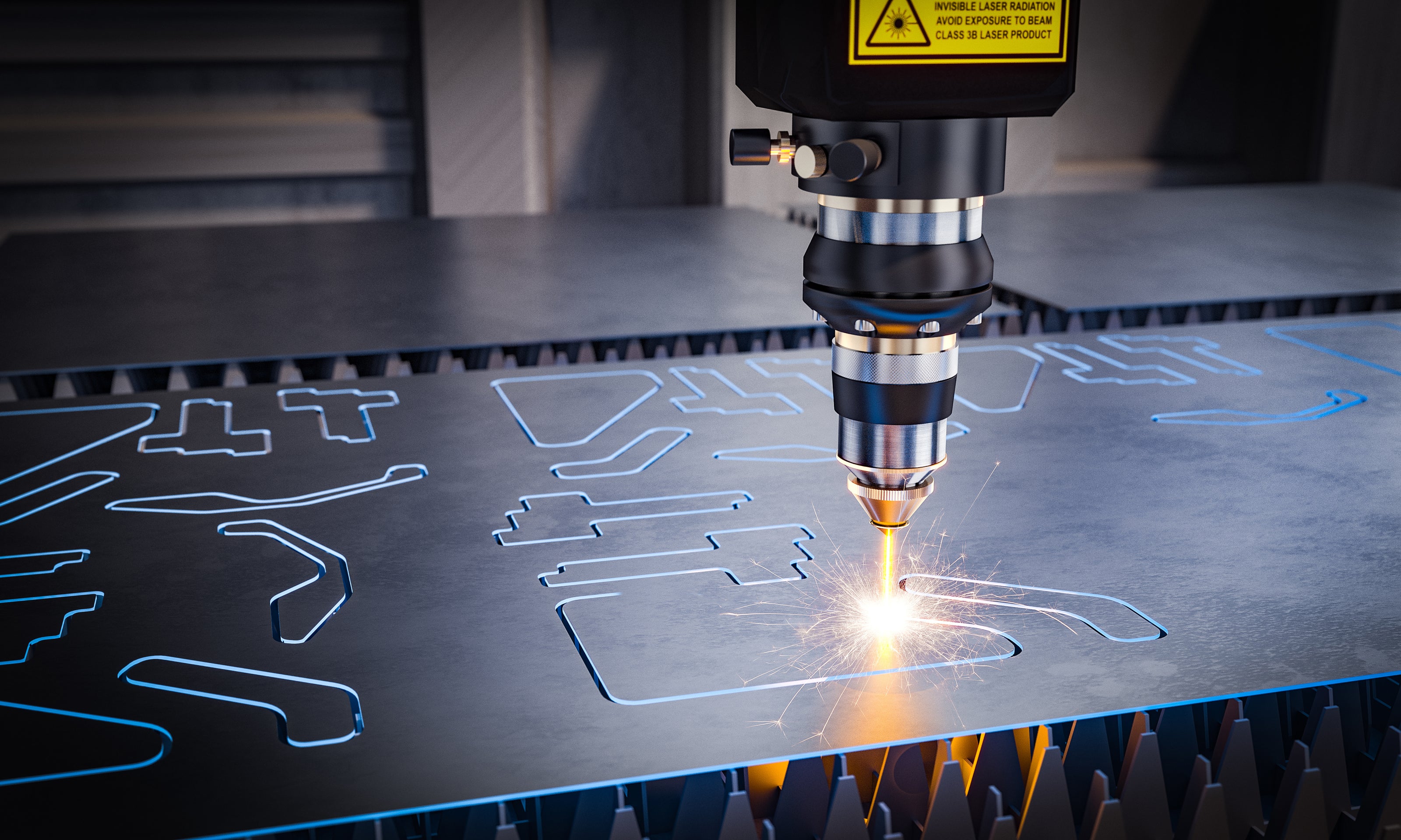 Laser cutting machine in action on a metal sheet with engraved patterns.